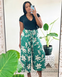 black woman wearing black v neck top green tropical pants guava honey summer outfits